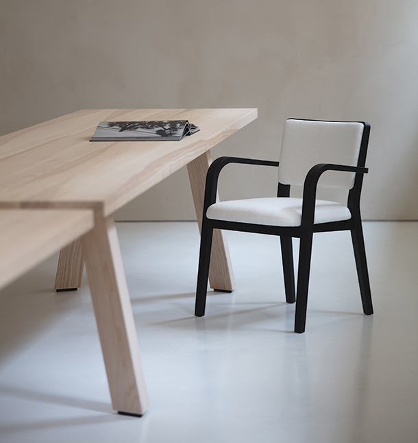 Solid ash wood table and wood chair with white upholstered chair and black stained legs and arm rests